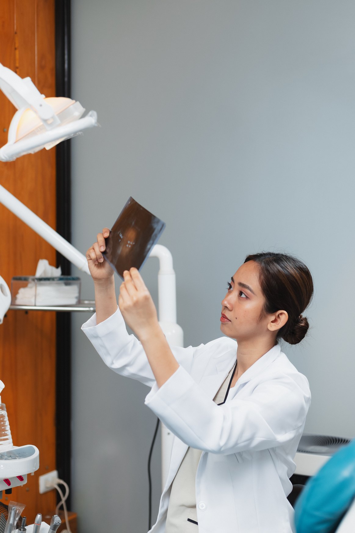 Female Dentist Examining Dental X-ray